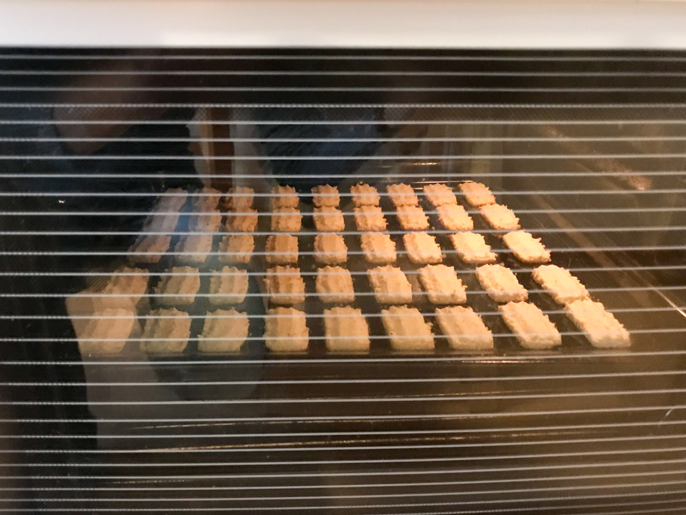 Coconut Christmas cookies in the oven.