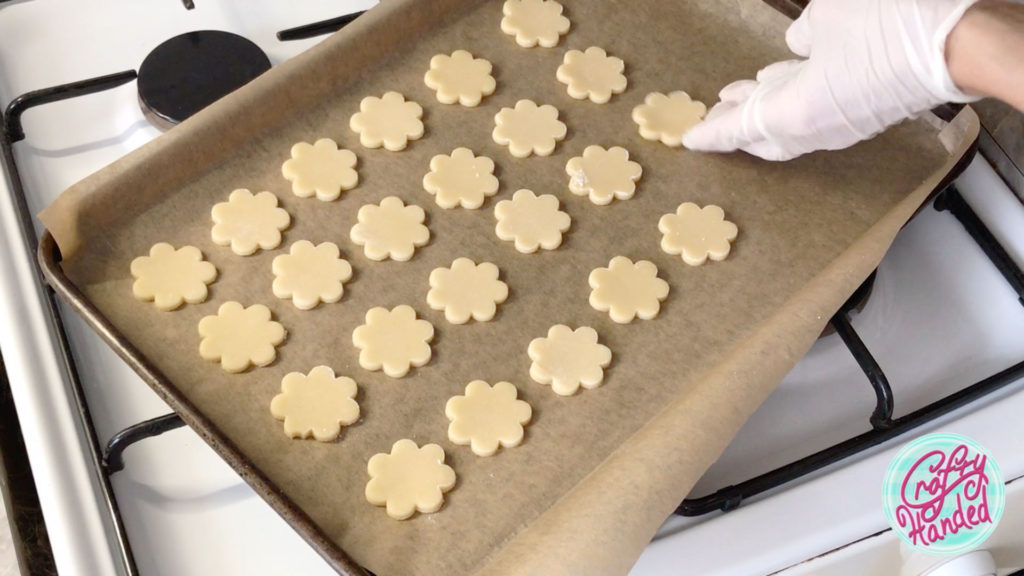 Cut out cookies on a lined baking sheet